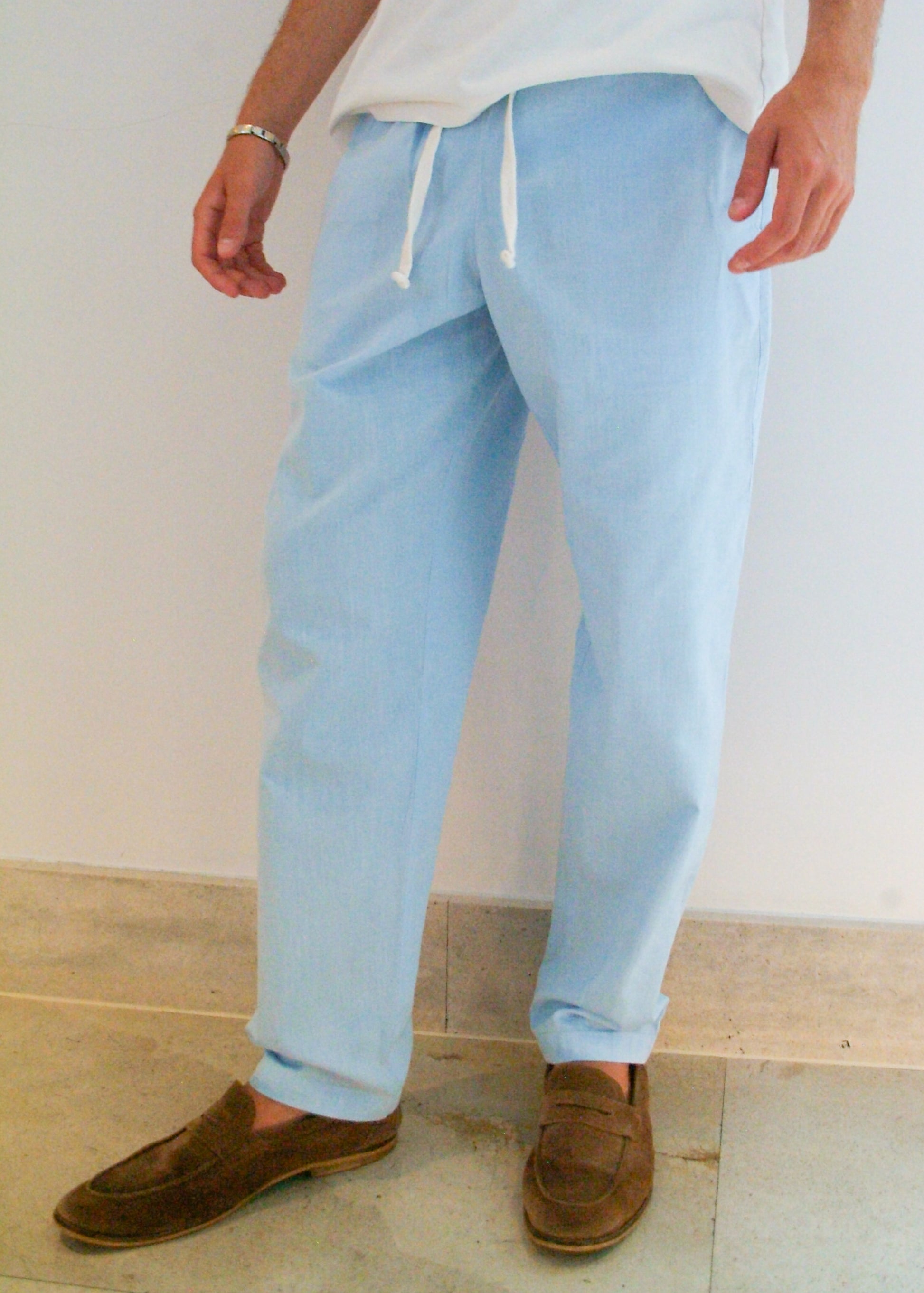 Light blue pants worn by a person on a plain background